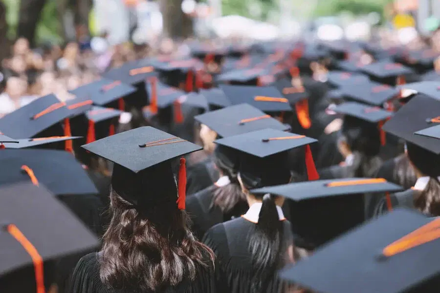 Graduation caps with orange tassels