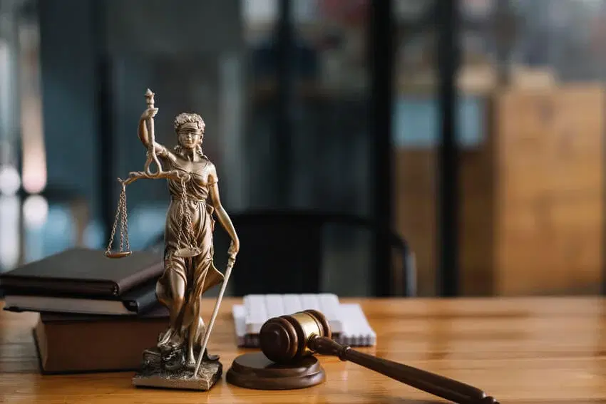 Lady Justice statue and gavel on a wooden desk